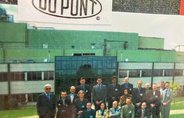 Group picture outside building with DuPont sign.